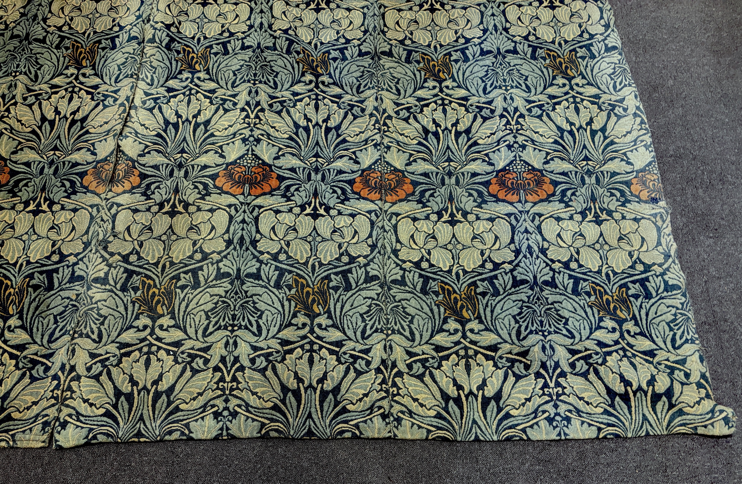 William Morris (1834-1896). Four panels of ‘Tulip and Rose’ triple woven wool and linen mix being two lengths sewn together creating a pair of wider curtains widest curtain (of two panels) 189cm wide x 158cm long, Single